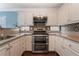 Functional kitchen with stainless appliances, stone countertops, and ample storage at 5779 Baffy Cir, Las Vegas, NV 89142