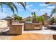 A beautiful outdoor kitchen with stone veneer, stainless steel grill, and sink, perfect for entertaining at 5779 Baffy Cir, Las Vegas, NV 89142