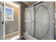 Bathroom shower with decorative glass doors, next to window and the exit at 5779 Baffy Cir, Las Vegas, NV 89142