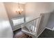 Staircase with contemporary chandelier offering a bright and stylish transition between floors at 5779 Baffy Cir, Las Vegas, NV 89142