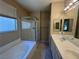 Bright bathroom with tub, walk-in shower, and double sink vanity at 5861 Varese Dr, Las Vegas, NV 89141