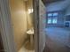 Powder room with pedestal sink next to open living room with staircase at 5861 Varese Dr, Las Vegas, NV 89141