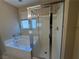 Bathroom features a separate tub and glass shower enclosure at 5861 Varese Dr, Las Vegas, NV 89141