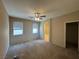 Spacious bedroom with ceiling fan, carpet flooring, and ensuite bathroom access at 5861 Varese Dr, Las Vegas, NV 89141