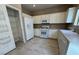 Well-lit kitchen includes white appliances, neutral cabinets, and ample countertop space for food preparation at 5861 Varese Dr, Las Vegas, NV 89141