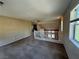 Spacious loft area with large windows, neutral paint, and comfortable carpeted floors at 5861 Varese Dr, Las Vegas, NV 89141