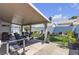Spacious covered patio featuring a table, chairs, exercise equipment and a view of the manicured yard at 5990 Ablette Ave, Las Vegas, NV 89122