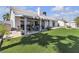 Beautiful backyard featuring a covered patio, manicured lawn and desert landscaping at 5990 Ablette Ave, Las Vegas, NV 89122