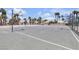 Well-maintained outdoor basketball court, perfect for sports and recreation, surrounded by swaying palm trees at 5990 Ablette Ave, Las Vegas, NV 89122