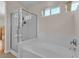 Bright bathroom featuring a glass enclosed shower, and a separate soaking tub at 5990 Ablette Ave, Las Vegas, NV 89122