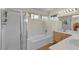 Spacious bathroom with a shower and bath combination, light walls and dual sinks with natural light at 5990 Ablette Ave, Las Vegas, NV 89122