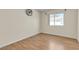 Clean and bright bedroom with hardwood floors and a large window at 5990 Ablette Ave, Las Vegas, NV 89122