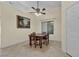 Dining area featuring tile floors, ceiling fan, and a large window with natural light at 5990 Ablette Ave, Las Vegas, NV 89122
