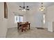 Dining area features tile floors, ceiling fan, and a large window with natural light at 5990 Ablette Ave, Las Vegas, NV 89122