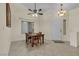 Dining area features tile floors, a ceiling fan, and neutral paint for a cozy space at 5990 Ablette Ave, Las Vegas, NV 89122