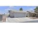 Single-story home featuring a two-car garage, concrete driveway, and low-maintenance landscaping at 5990 Ablette Ave, Las Vegas, NV 89122