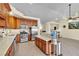 Spacious kitchen with wooden cabinets, modern appliances, and an island at 5990 Ablette Ave, Las Vegas, NV 89122