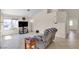 Bright living room with tile flooring, large windows, and a comfortable recliner at 5990 Ablette Ave, Las Vegas, NV 89122