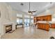 Spacious living area featuring a fireplace, tile flooring, and open access to the kitchen at 5990 Ablette Ave, Las Vegas, NV 89122