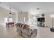 Open-concept living room featuring tile flooring, neutral tones, and a dining area at 5990 Ablette Ave, Las Vegas, NV 89122