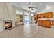 Open living area with tile flooring, fireplace, and a view of the kitchen and patio at 5990 Ablette Ave, Las Vegas, NV 89122