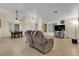 Spacious living area with tile floors, neutral wall colors, and a dining table visible at 5990 Ablette Ave, Las Vegas, NV 89122