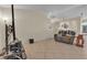 Open living area with tile flooring, neutral walls, and space for comfortable seating at 5990 Ablette Ave, Las Vegas, NV 89122