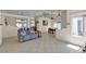 Open floor plan living space with neutral tones and tile flooring throughout at 5990 Ablette Ave, Las Vegas, NV 89122