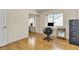 Well lit office features light wood flooring, a window and office desk and chair at 5990 Ablette Ave, Las Vegas, NV 89122