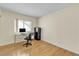 Bright office space with a window view, hardwood floors, a desk and chair with natural light filtering in at 5990 Ablette Ave, Las Vegas, NV 89122