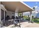 Spacious covered patio featuring a table, chairs, exercise equipment and a view of the yard at 5990 Ablette Ave, Las Vegas, NV 89122