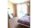 Cozy bedroom with carpet flooring, white frame bed, and sliding door to the outside at 6374 Horizon Ridge Ct, Las Vegas, NV 89156
