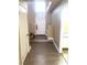 Warm and inviting entryway featuring wood-look floors, a white front door, and access to the stairs at 6374 Horizon Ridge Ct, Las Vegas, NV 89156