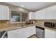 Bright kitchen with white cabinets, stainless steel appliances, and a window providing natural light at 6374 Horizon Ridge Ct, Las Vegas, NV 89156