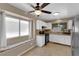 Bright kitchen features white cabinets, tile floors, stainless steel appliances, and breakfast nook with window seat at 6374 Horizon Ridge Ct, Las Vegas, NV 89156