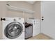 Convenient laundry room featuring a modern washer, dryer, and ample storage space at 6374 Horizon Ridge Ct, Las Vegas, NV 89156