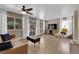 Bright living room with wood-look tile flooring, large windows, neutral paint and modern furnishings at 6374 Horizon Ridge Ct, Las Vegas, NV 89156