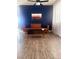 Stylish living room with blue accent wall, wood-look floors, and comfortable modern furniture at 6374 Horizon Ridge Ct, Las Vegas, NV 89156