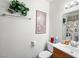 Neutral bathroom with a single sink vanity, artwork, toilet, and towel rack at 6630 Bubbling Brook Dr # C, Las Vegas, NV 89107