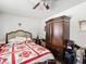 Bedroom showcasing a bed with a patterned quilt, a ceiling fan, and wooden armoire at 6630 Bubbling Brook Dr # C, Las Vegas, NV 89107