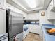 Functional kitchen featuring stainless steel refrigerator, white appliances, and clean, white cabinets at 6630 Bubbling Brook Dr # C, Las Vegas, NV 89107