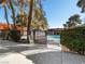 Community pool with black metal fence and view of surrounding buildings at 6630 Bubbling Brook Dr # C, Las Vegas, NV 89107