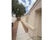 Side exterior showcasing stucco walls, trimmed windows and concrete sidewalk at 6642 Cinnabar Coast Ln, North Las Vegas, NV 89084