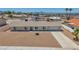 View of the single story home featuring desert landscaping and a concrete driveway at 6727 E Washington Ave, Las Vegas, NV 89110