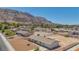 Aerial view of a desert home showcasing desert landscaping and mountains in the background in a suburban neighborhood at 6727 E Washington Ave, Las Vegas, NV 89110