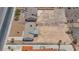 Aerial view of a single story home with surrounding desert land and neighborhood at 6727 E Washington Ave, Las Vegas, NV 89110