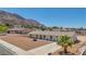 Aerial view of a one story home featuring mountain views and desert landscaping at 6727 E Washington Ave, Las Vegas, NV 89110