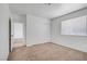 Bedroom featuring neutral carpet, white walls, and a closet with sliding doors at 6727 E Washington Ave, Las Vegas, NV 89110