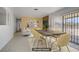 A dining room showcases a rustic wood table and modern chairs complemented by artwork at 6727 E Washington Ave, Las Vegas, NV 89110