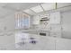 The bright kitchen features white backsplash, tile countertops, and updated appliances at 6727 E Washington Ave, Las Vegas, NV 89110